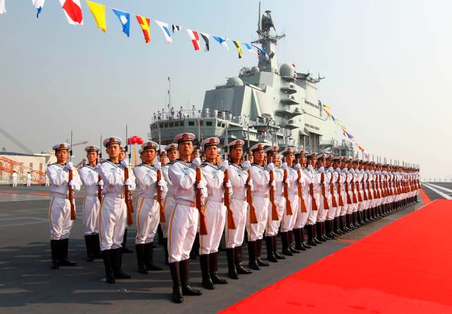 Naval honour guards stand as they wait for a review on China's aircraft carrier "Liaoning" in Dalian, Liaoning province, September 25, 2012. China's first aircraft carrier was delivered and commissioned to the Navy of the Chinese People's Liberation Army on Tuesday after years of refitting and sea trials. REUTERS/Xinhua/Zha Chunming (CHINA - Tags: MILITARY POLITICS) NO SALES. NO ARCHIVES. FOR EDITORIAL USE ONLY. NOT FOR SALE FOR MARKETING OR ADVERTISING CAMPAIGNS. THIS IMAGE HAS BEEN SUPPLIED BY A THIRD PARTY. IT IS DISTRIBUTED, EXACTLY AS RECEIVED BY REUTERS, AS A SERVICE TO CLIENTS. CHINA OUT. NO COMMERCIAL OR EDITORIAL SALES IN CHINA. YES